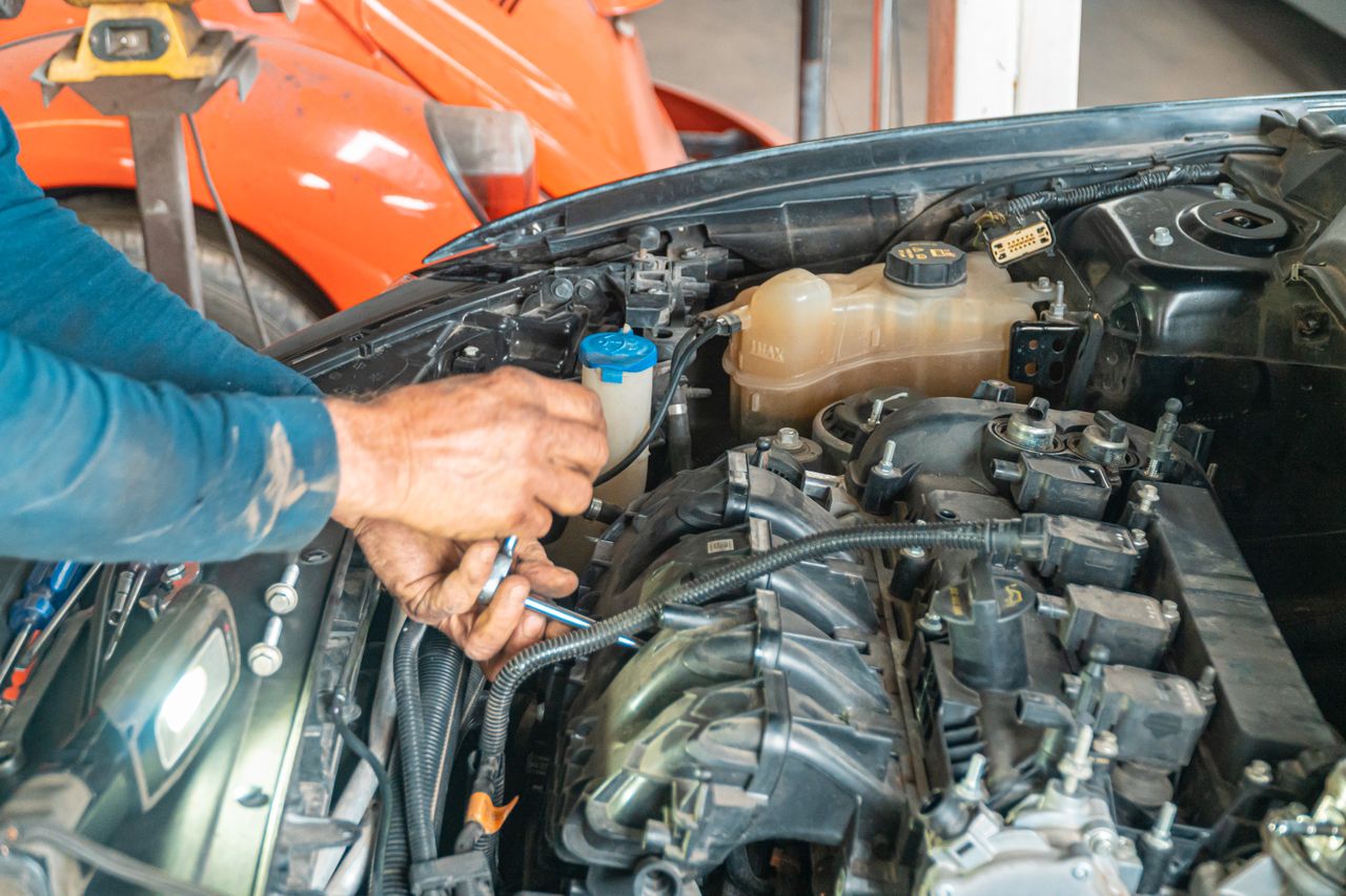 Certified mechanic performing engine diagnostics